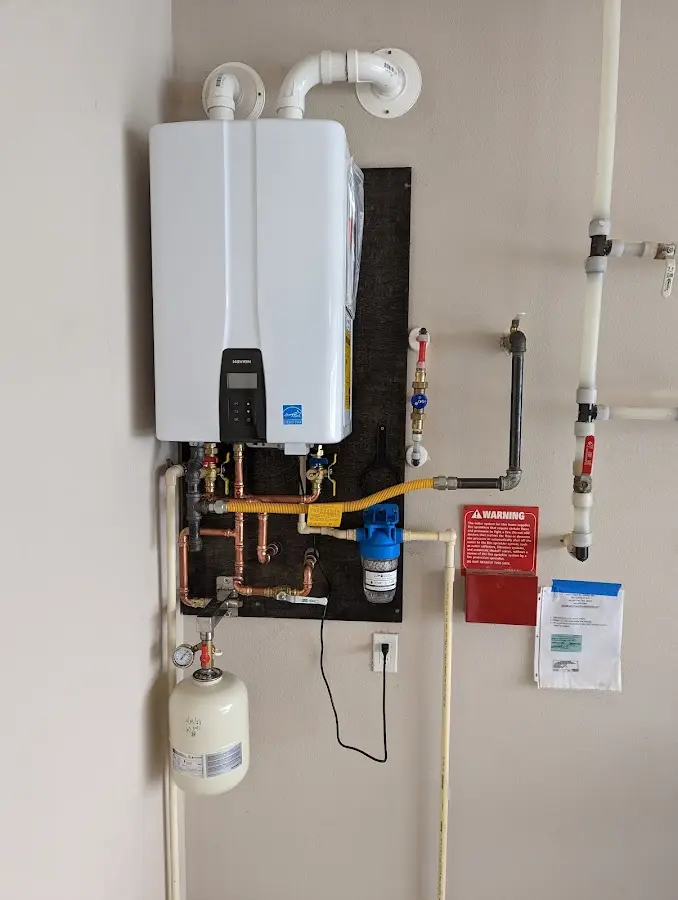 Professional plumber installing copper piping in a White House home